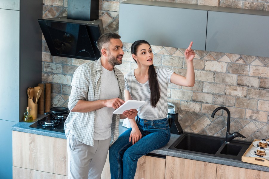  A couple using smart home devices through a tablet