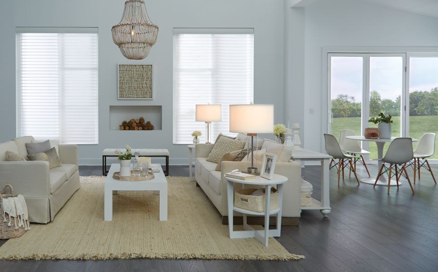 A softly lit open-concept living area with shades lowered.