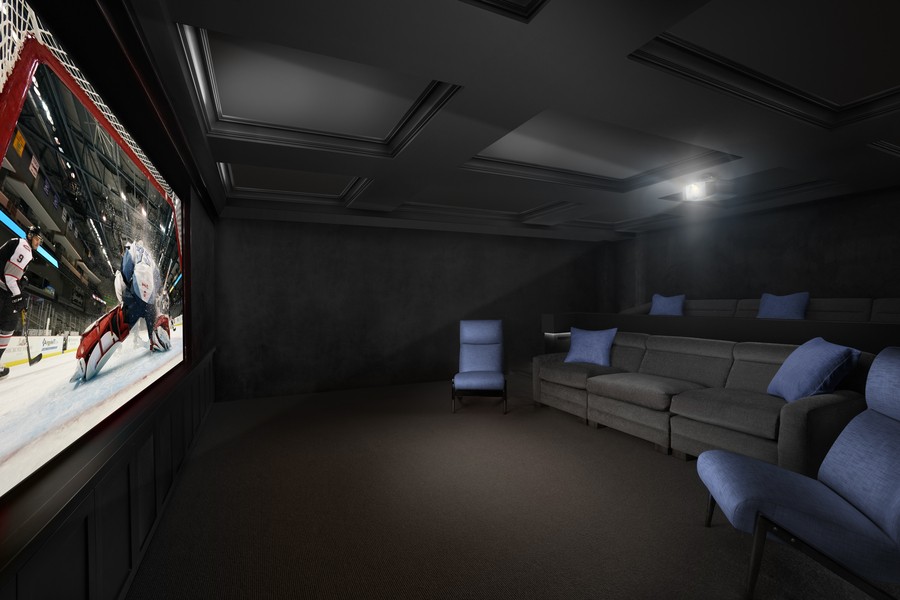 a custom home theater with a projector and comfortable couches