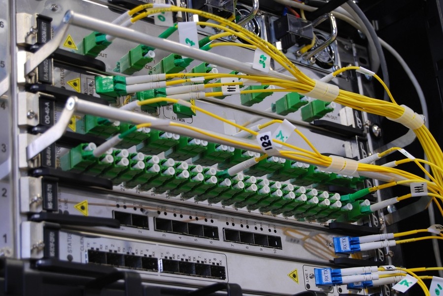 A panel with many green wires coming out of it 