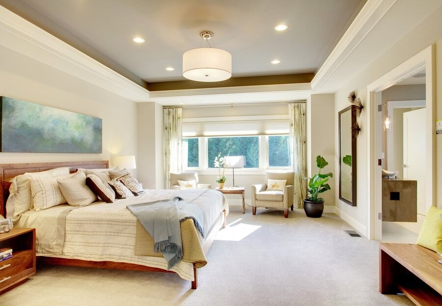 A bedroom with several smart home technologies, such as lighting control and automated window treatments, integrated throughout the room.