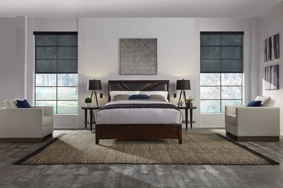 A bedroom featuring Lutron shades on either side of the bed.
