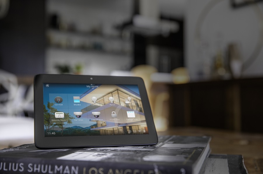 a tabletop touchscreen device sitting on a pile of books