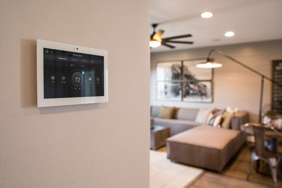 A living space featuring a Control4’s interface for a smart home control system.